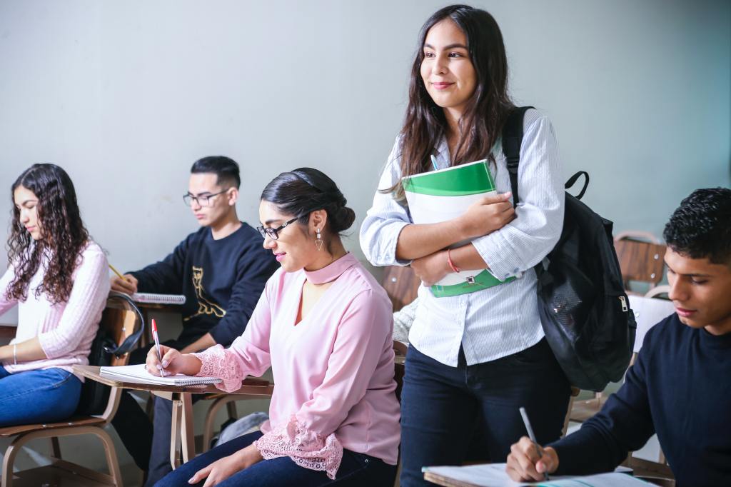 Image of a female student in a classroom with other students.